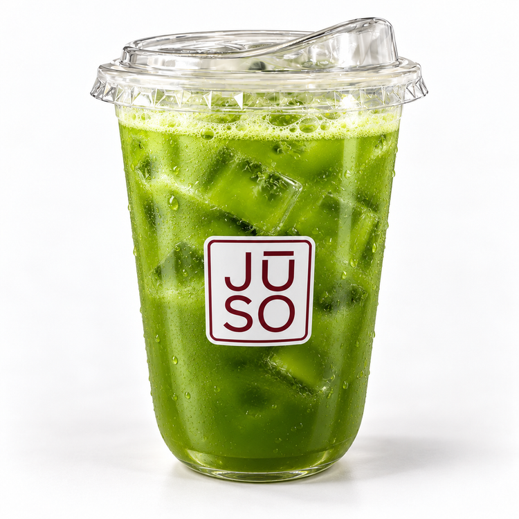 JŪSO Green Flag green juice served over ice in a branded clear cup